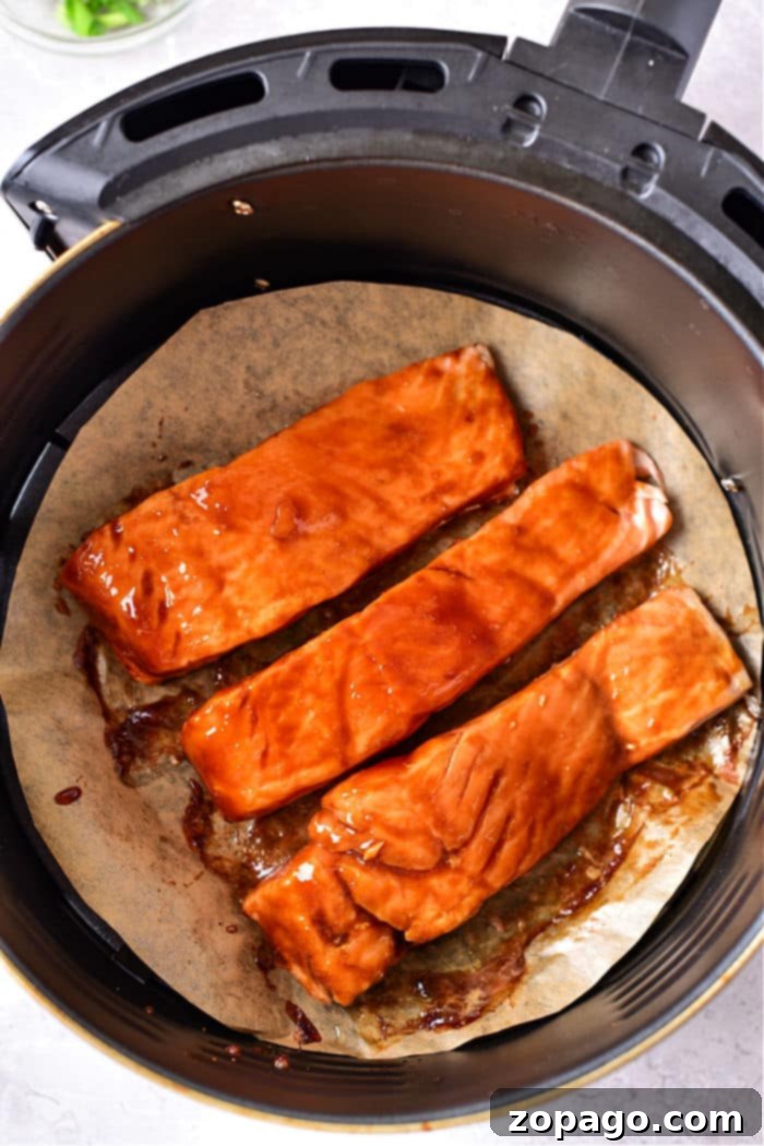 Sticky Air Fryer Teriyaki Salmon 5 Honey Teriyaki Salmon Air Fryer - garnished with sesame seeds and green onions for a vibrant presentation.