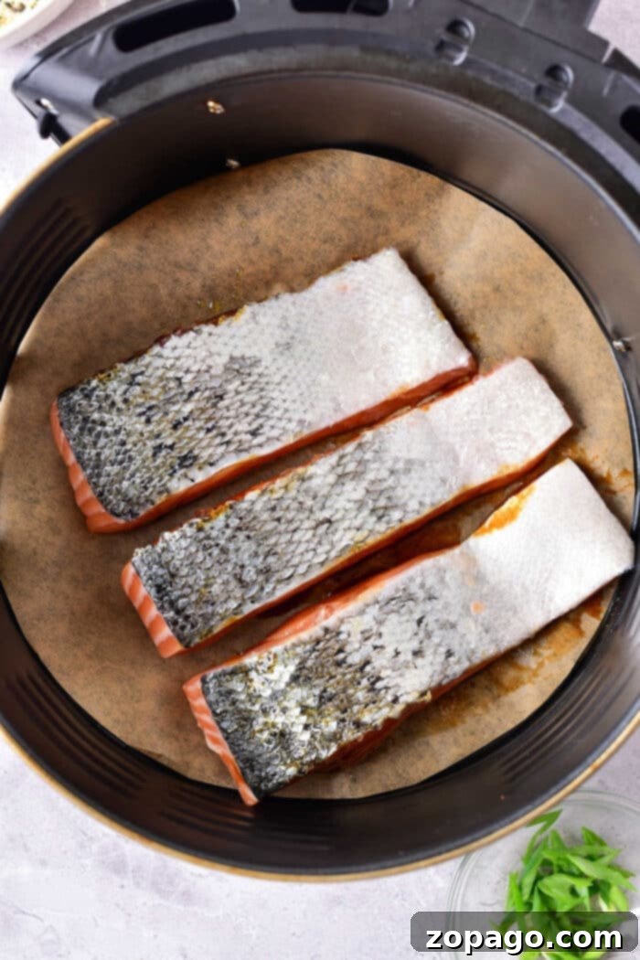 Sticky Air Fryer Teriyaki Salmon 9 Air Fryer Salmon with Skin - a close-up showing the crispy skin and moist, flaky flesh of perfectly cooked salmon.