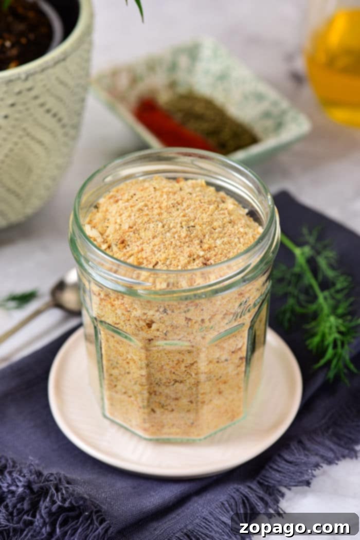 Crumbly Perfection From Your Kitchen 5 A wooden bowl overflowing with freshly made seasoned breadcrumbs, garnished with herbs.