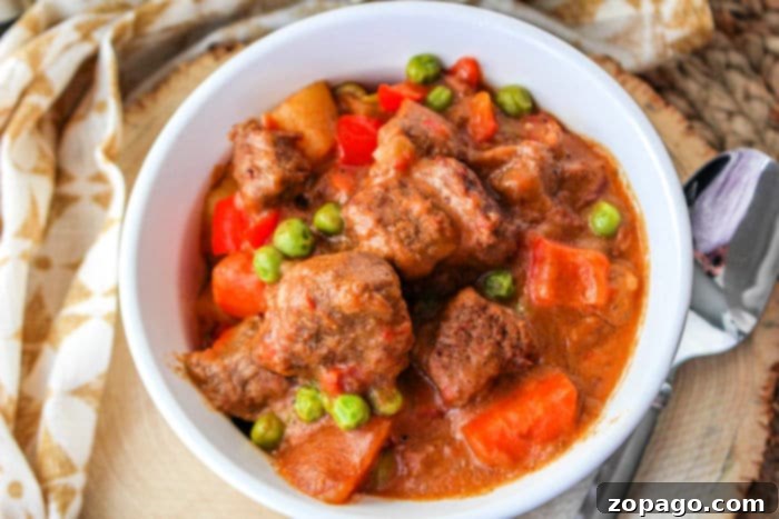 Boricua Beef Guisado 7 A close-up shot of rich Puerto Rican beef stew with tender meat, potatoes, and carrots, ready to be enjoyed.