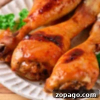 How Long to Roast Chicken Drumsticks at 400F 7 baked chicken drumsticks, perfectly cooked to juicy perfection, rest on a plate with a parsley garnish. Wondering how long to bake chicken drumsticks at 400 degrees? This dish captures the essence of both methods for delightful tenderness.