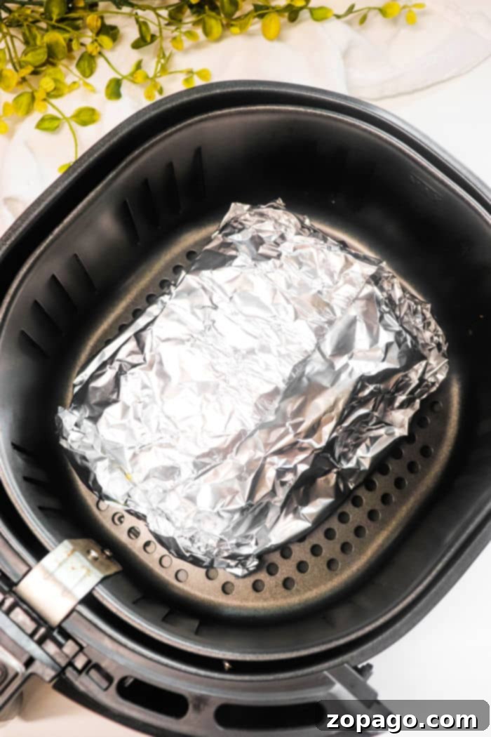 Perfect Air Fryer Corned Beef 6 Deliciously cooked corned beef in an air fryer basket, ready to be served.