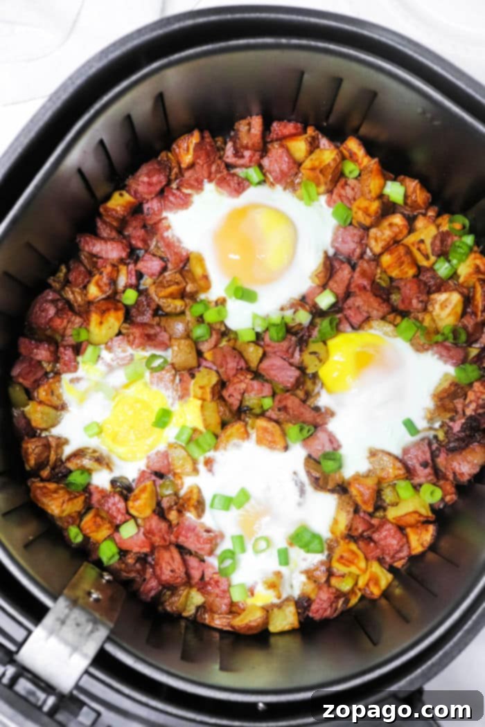 Crispy Air Fryer Corned Beef Hash 2 Crispy Air Fryer Corned Beef Hash with perfectly diced potatoes and tender corned beef, garnished with fresh herbs.