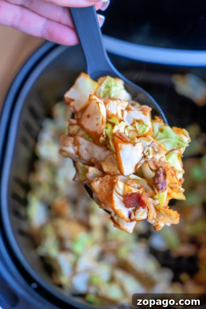 Crispy Air Fryer Cabbage 2 Golden brown and tender-crisp fried cabbage, perfectly cooked in an air fryer and garnished with savory bacon bits, ready to be served as a delicious side dish.