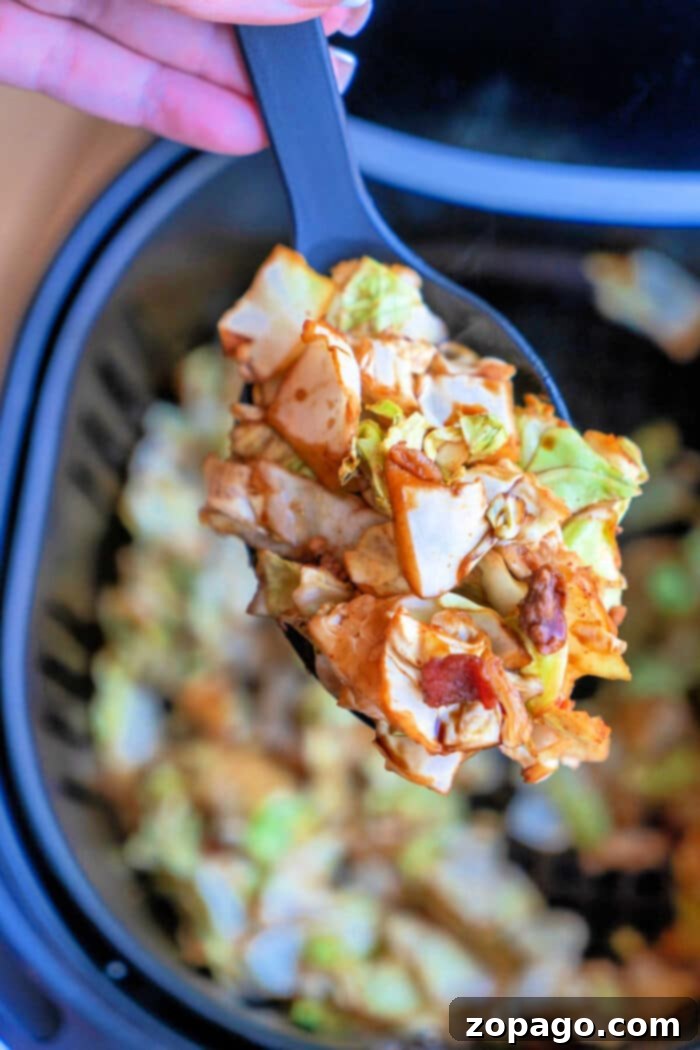 Crispy Air Fryer Cabbage 10 A vibrant bowl of Air Fryer Fried Cabbage, perfectly tender-crisp with hints of seasoning, sits invitingly on a clean white surface, ready to be enjoyed.