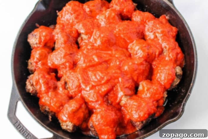 Stovetop Meatball Recipe 6 Hearty skillet spaghetti with tender meatballs, beautifully presented and ready to be served directly from a rustic cast iron pan.