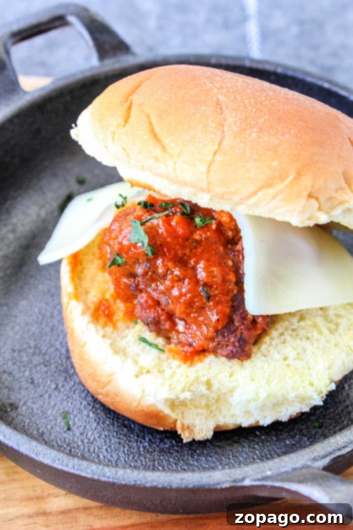 Easy Skillet Meatballs 7 Meatball sliders made with small buns, juicy meatballs, and melted cheese, served as a fun appetizer or meal.