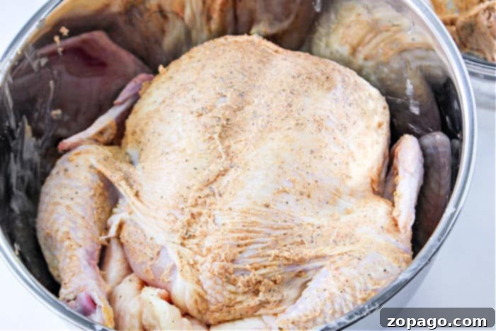 Homemade Rotisserie Style Chicken 4 How Long to Bake a Whole Chicken at 375: A close-up of a perfectly roasted whole chicken, showcasing its crispy golden skin, resting in a Bundt pan.