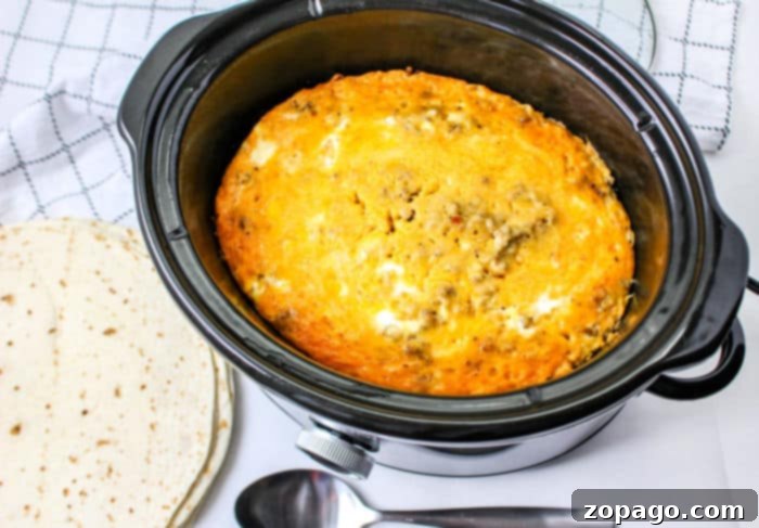 Effortless Slow Cooker Breakfast Scramble 5 Fluffy slow cooker scrambled eggs with melted cheese, ready for serving.