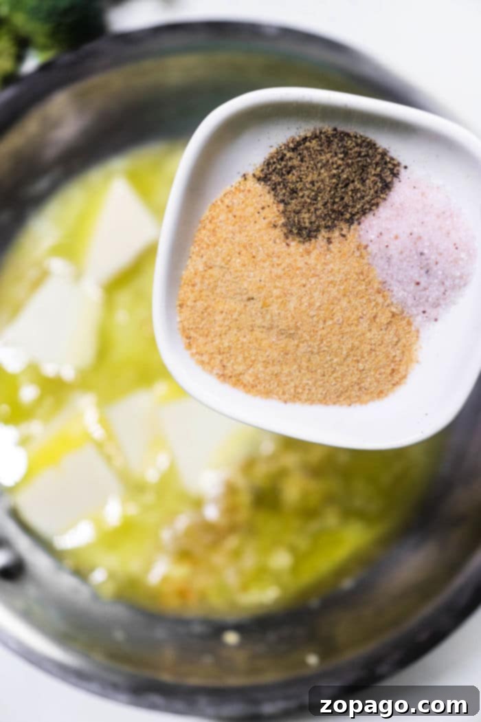 Cajun Garlic Butter Drizzle 7 Rich butter sauce with visible garlic pieces, perfect for enhancing any meal.