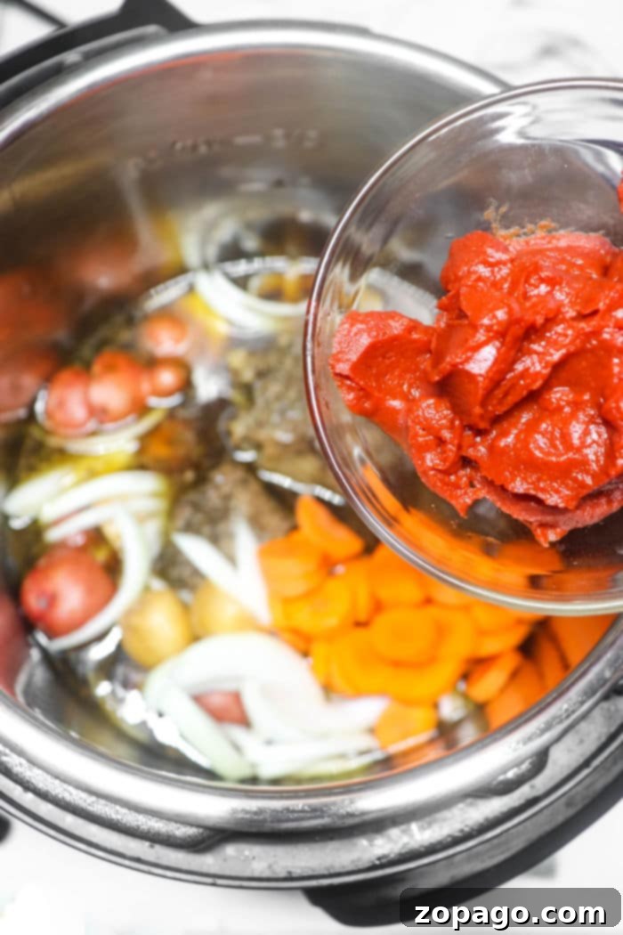 Fall Apart Tender Instant Pot Oxtail Soup 4 Instant Pot Oxtail Stew served in a bowl, garnished with fresh herbs.
