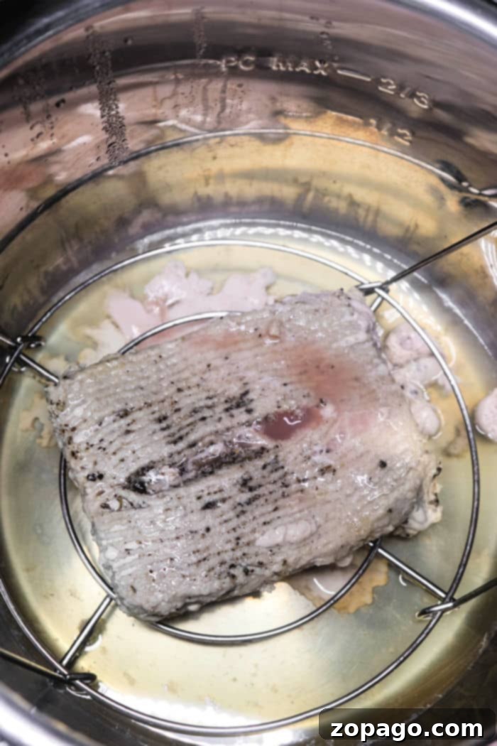 Ninja Foodi Frozen Ground Turkey being sautéed and crumbled