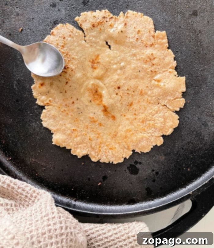 Roti cooking on a skillet, demonstrating the simple home method for preparing this Indian flatbread.