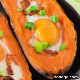 Pressure Cooker Sweet Potatoes with eggs, crispy bacon, and chopped green onions on top, served on a sleek black plate.