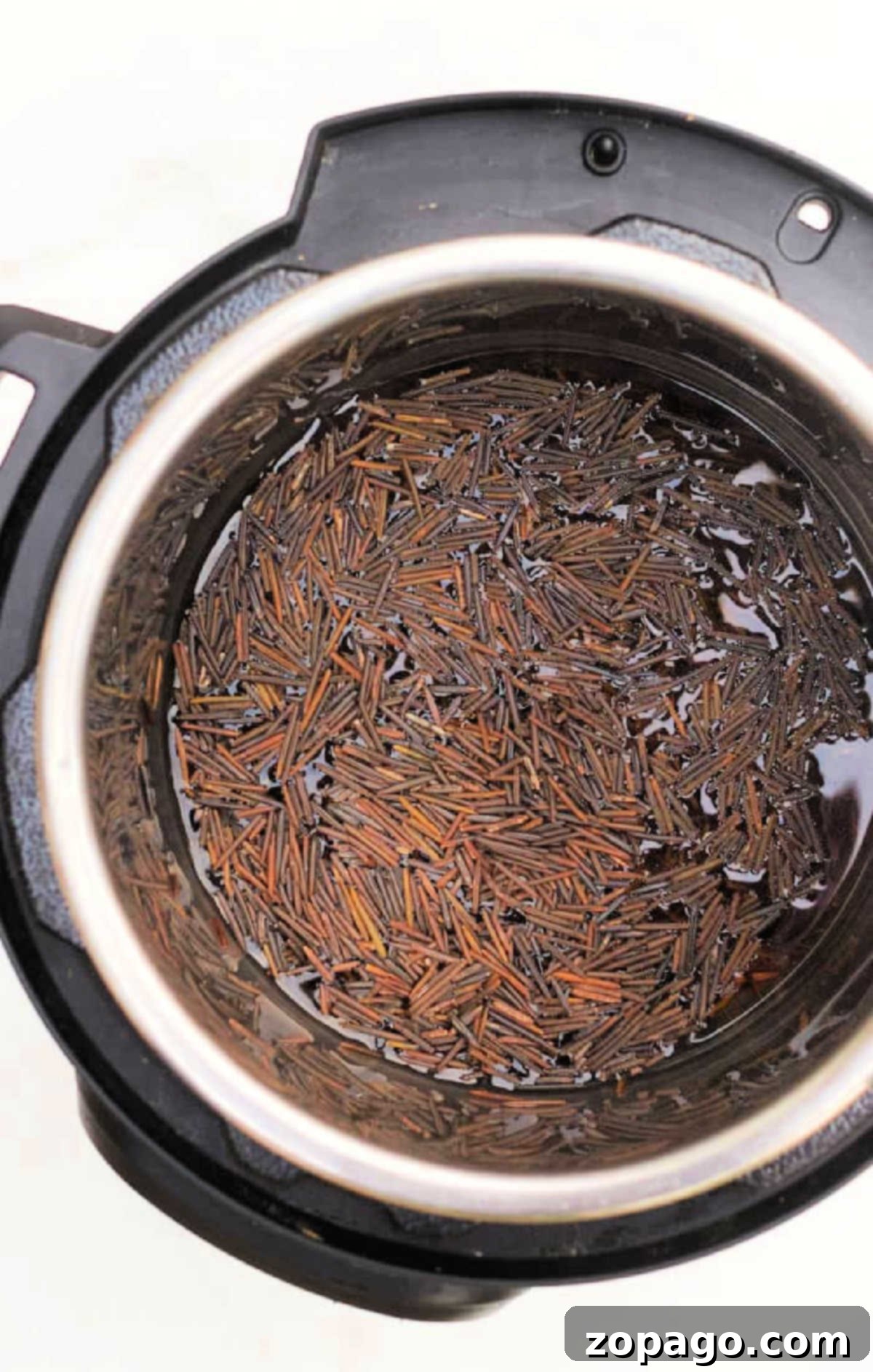Perfect Instant Pot Black Rice 4 Uncooked wild and black rice soaking in water inside an Instant Pot, viewed from above.