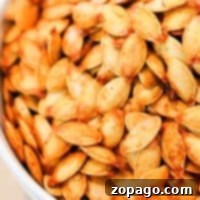 A close-up of a bowl brimming with roasted spaghetti squash seeds delivers a crunchy delight.