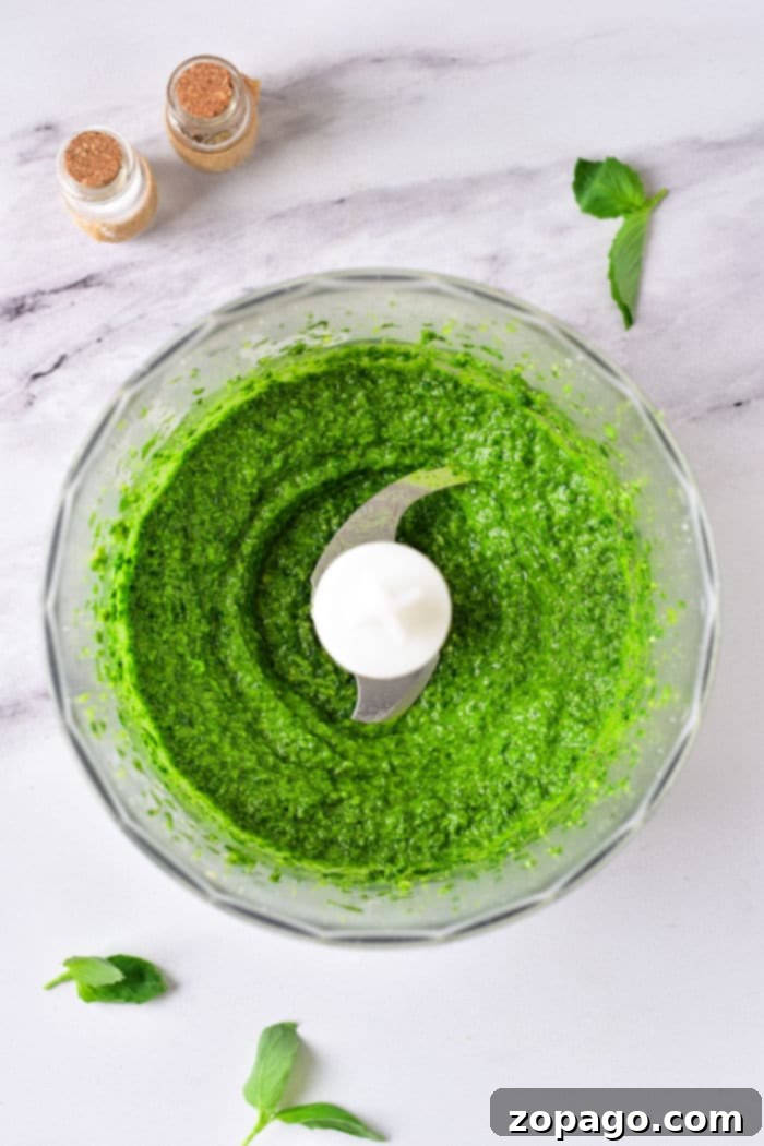 Ultimate Air Fryer Pesto Chicken 3 Homemade Pesto Without Nuts - a vibrant green, freshly made pesto in a glass jar, showing its rich texture.