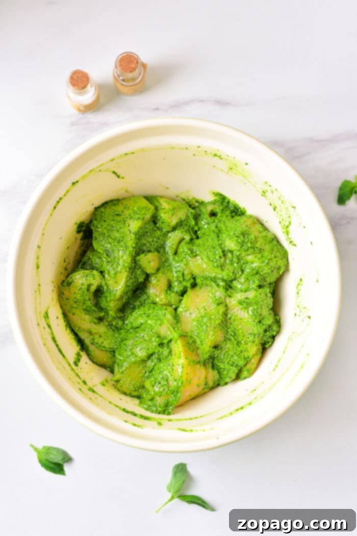 Ultimate Air Fryer Pesto Chicken 4 Pesto Chicken Thighs - crispy, golden-brown chicken thighs coated in a rich green pesto sauce.