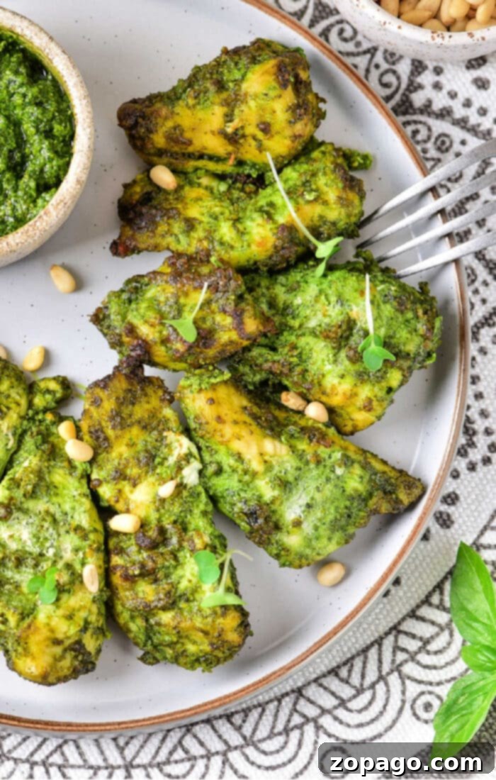 Ultimate Air Fryer Pesto Chicken 8 Air Fryer Pesto Chicken - cooked chicken strips with pesto on a serving plate, ready to be enjoyed.