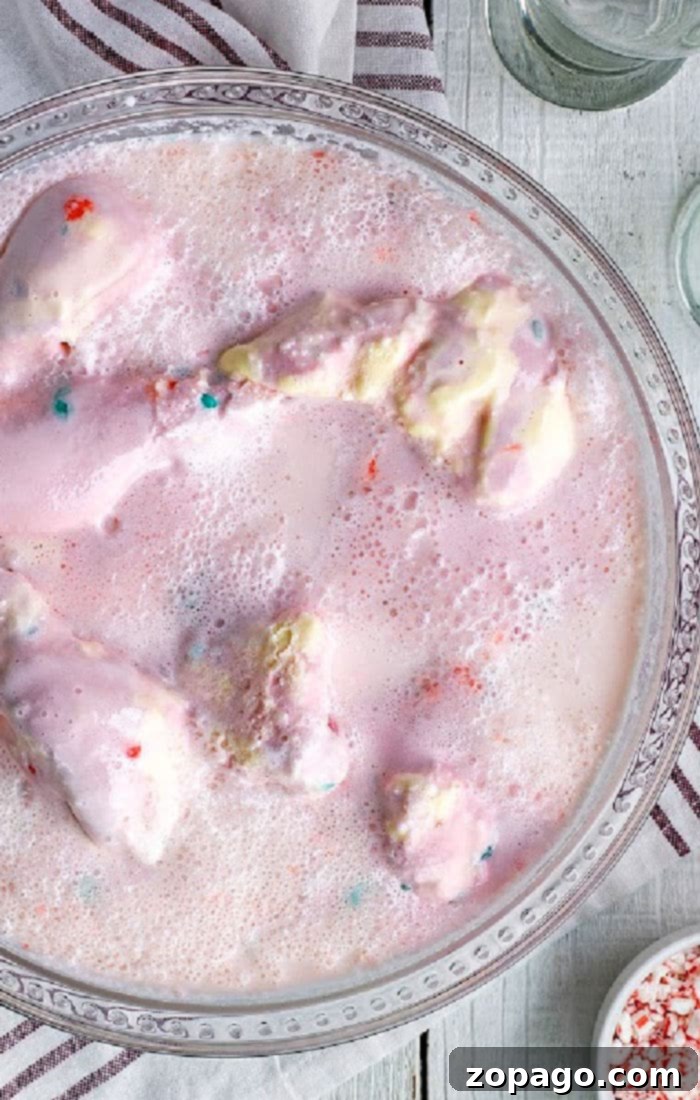 Pretty in Pink Party Punch 5 Festive Peppermint Punch garnished with candy canes, perfect for Christmas.