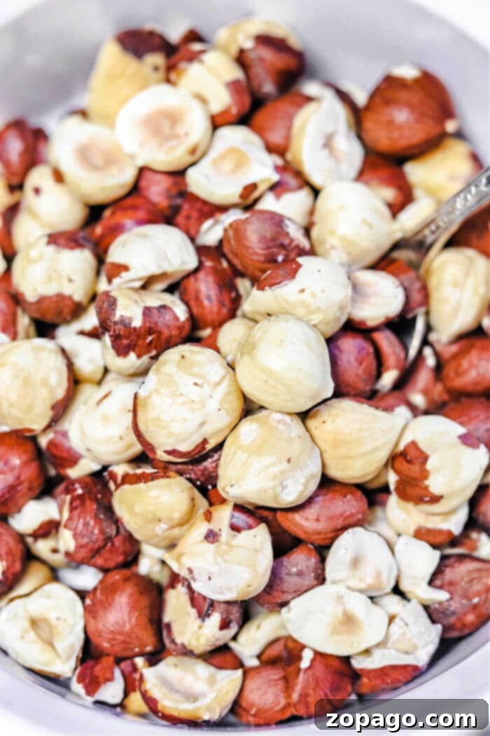 Unlock Hazelnut Flavor 2 Toasting Hazelnuts - A close-up of raw and roasted hazelnuts ready to be prepared.