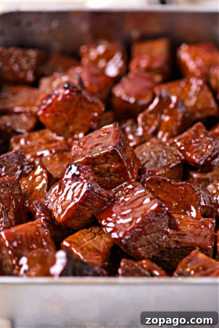 Smoky Chuck Roast Burnt Ends 2 Close-up of perfectly glazed chuck roast burnt ends in a serving dish, glistening with sauce