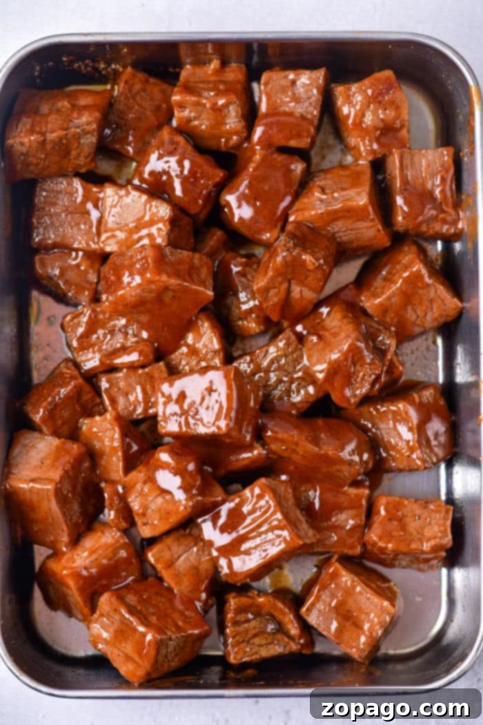 Smoky Chuck Roast Burnt Ends 6 A delicious serving of oven-baked burnt ends, glistening with barbecue sauce, ready to be enjoyed
