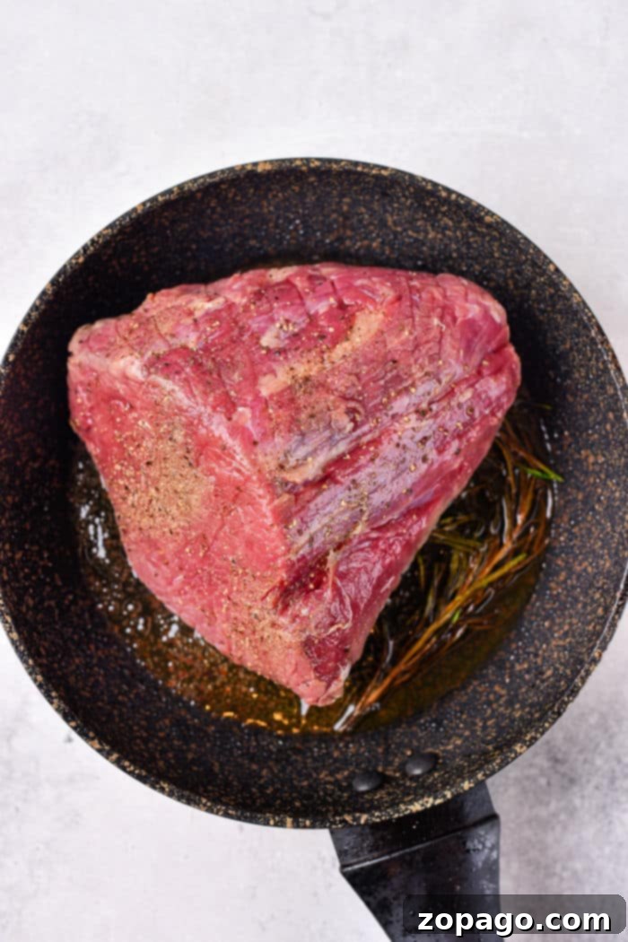 Melt in Your Mouth Tender Roast Beef 4 How to Cook Roast Beef in Oven - Sliced roast beef on a cutting board.