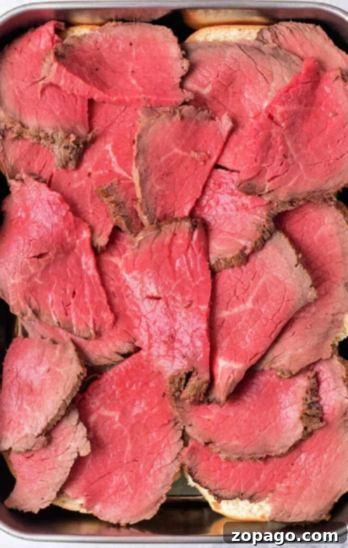 Melt in Your Mouth Tender Roast Beef 8 How to Cook Melt in your Mouth Roast Beef - Sliced roast beef on a plate with gravy.