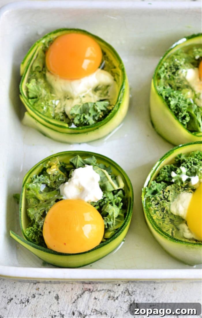 Zucchini Sunshine Eggs 4 Individual baked zucchini egg cups in a baking dish.