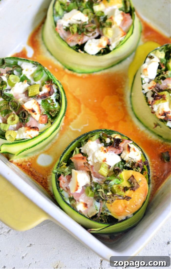 Zucchini Sunshine Eggs 5 A selection of baked zucchini egg cups in a large baking dish, garnished and ready to eat.
