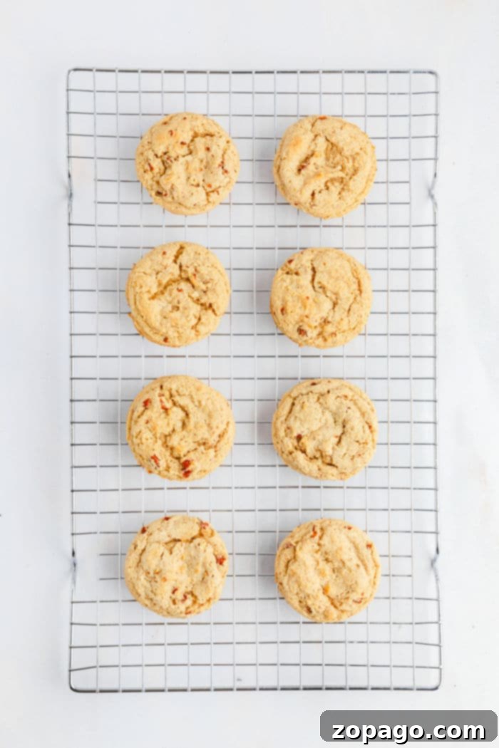 Eight butter pecan Cookies cooling on a wire rack, arranged in two neat columns on a white background.