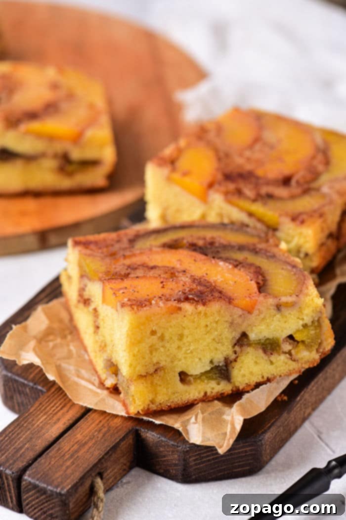 Sun-Kissed Peach Cake 6 Slices of spiced peach upside-down cake rest invitingly on a wooden board.