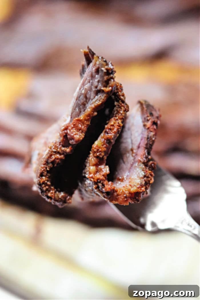 Pitmaster's Choice Smoked Brisket 6 A delicious Traeger pellet smoker brisket, sliced and ready to serve, showcasing its juicy interior.