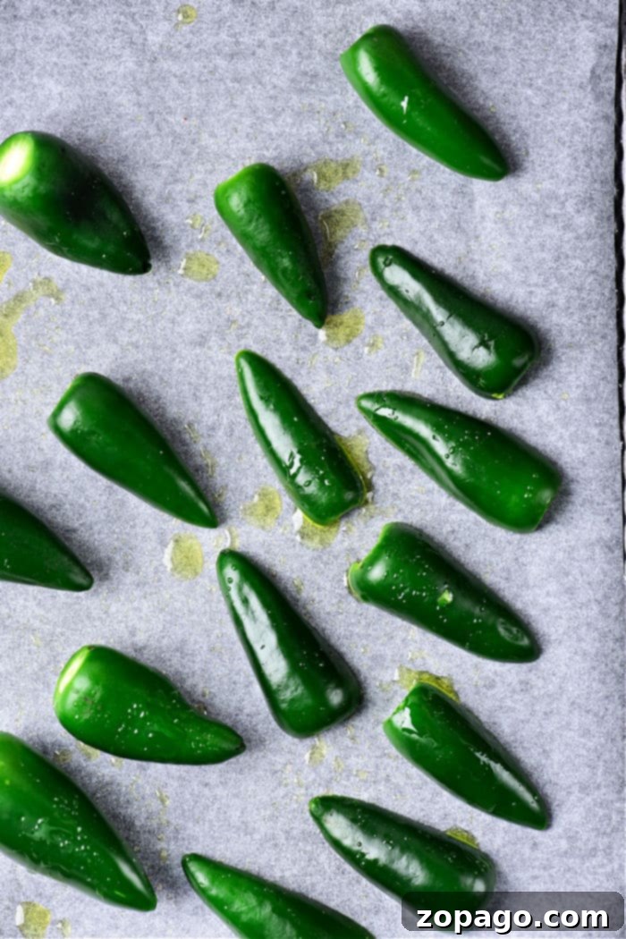 Oven-Roasted Jalapeños 4 Roasted jalapenos in various stages of charring, ready to be peeled and used for salsa.