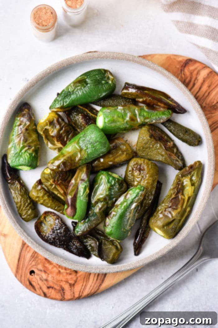 Oven-Roasted Jalapeños 6 A vibrant selection of oven roasted jalapenos, perfectly charred, resting on a baking sheet.