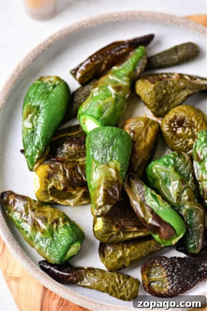 Oven-Roasted Jalapeños 7 A serving of perfectly oven roasted jalapeño peppers, steaming gently on a wooden board, ready to be enjoyed.
