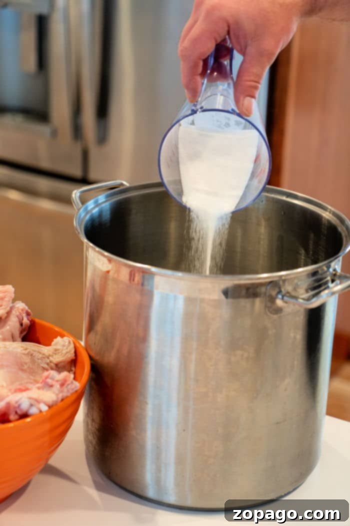 Juicy Turkey Brine 4 Turkey Brine Recipe for Smoking being prepared by hand.