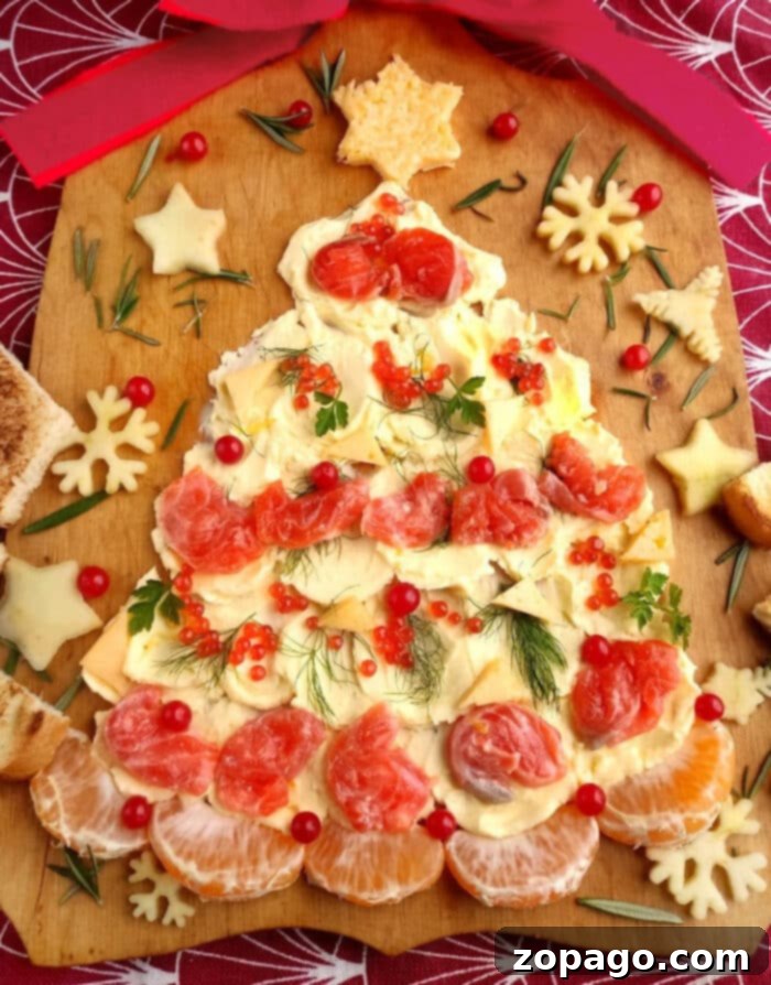A grand, beautifully presented Christmas Butter Board, shaped like a tree, adorned with colorful toppings and ready for holiday celebration.