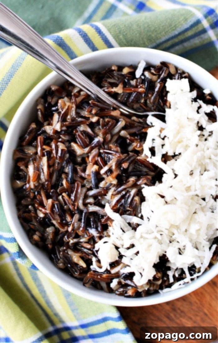 A beautifully presented bowl of black rice pudding, rich in color and texture.