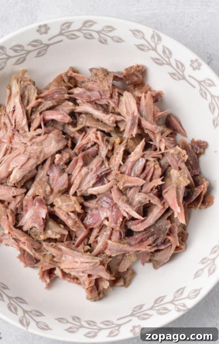 Slow-Simmered Turkey Neck Gravy 4 Close-up of shredded, rich turkey neck meat, ready to be incorporated into the gravy.