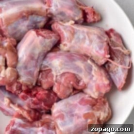 Raw turkey neck pieces in a bowl, prepared for boiling