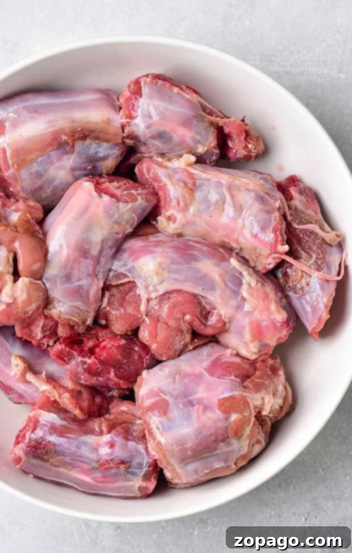 Tender Boiled Turkey Necks 8 Raw turkey neck pieces in a white bowl, ready for preparation