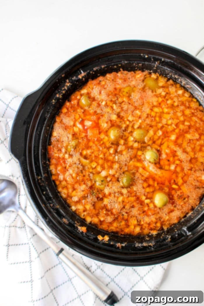 Chicken Stew 8 A large pot of slow cooker Pollo Guisado, ready to be served, showcasing its rich sauce and tender ingredients.