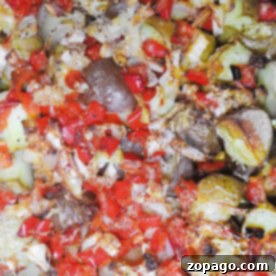 Close-up of smoked roasted potatoes with diced red peppers, onions, and herbs.
