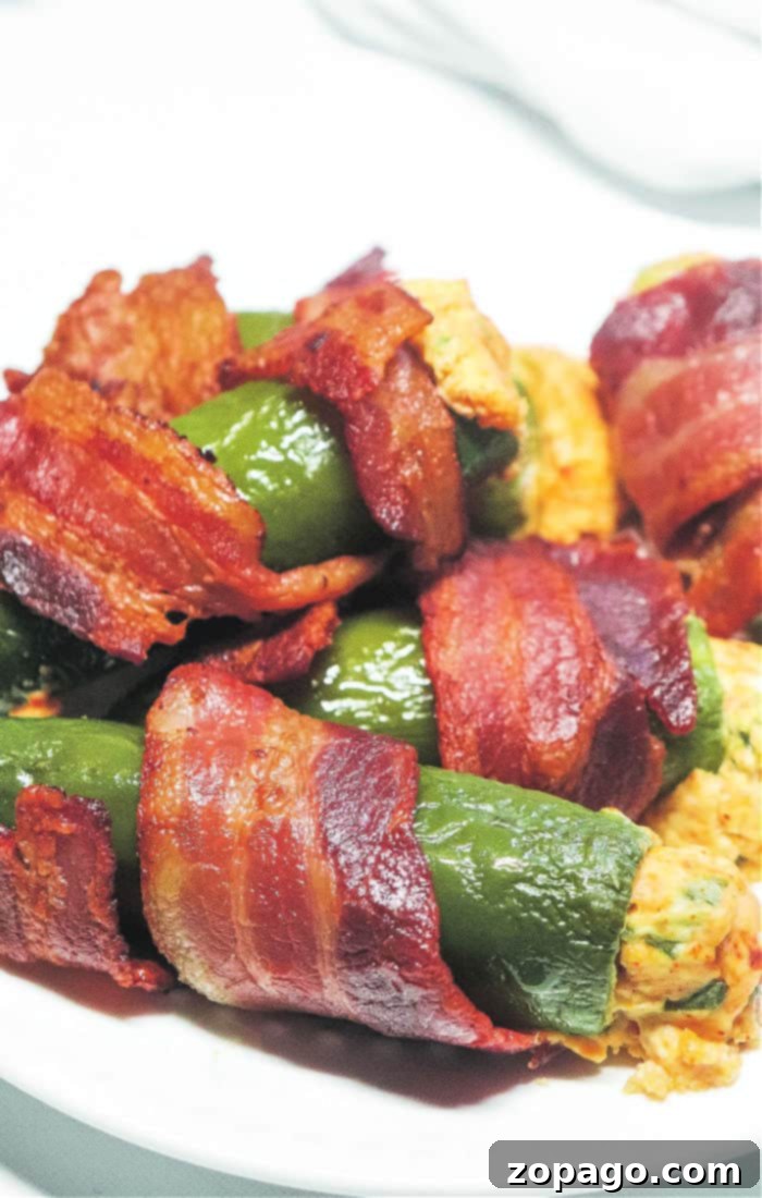 Delicious Smoked Jalapeno Poppers at 350 2 Smoked Bacon Wrapped Jalapeno Poppers, golden brown and perfectly cooked on a smoker grill.