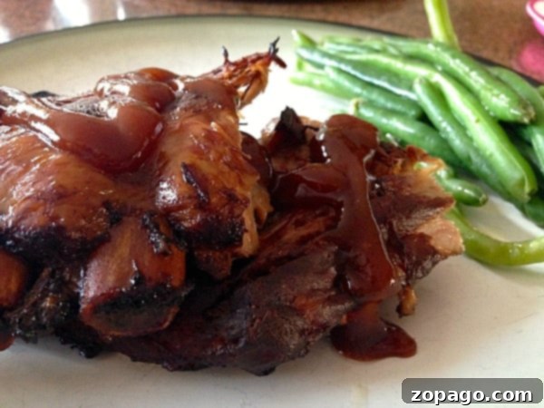 Best crockpot ribs recipe I've ever had!! Fall off the bone juicy ribs every time! If you've never made beef or pork ribs in your slow cooker they taste amazing with no effort on your part. A little time in the oven with this simple rub makes them one of our favorite dinners ever. #crockpot #slowcooker #ribs #recipe #rub #best #pork #beef Best ribs recipe: A close-up of perfectly cooked ribs, highlighting the juicy meat and glistening barbecue sauce, inviting you to take a bite.