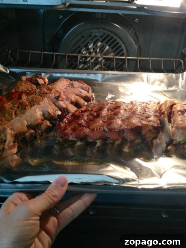 Best crockpot ribs recipe I've ever had!! Fall off the bone juicy ribs every time! If you've never made beef or pork ribs in your slow cooker they taste amazing with no effort on your part. A little time in the oven with this simple rub makes them one of our favorite dinners ever. #crockpot #slowcooker #ribs #recipe #rub #best #pork #beef How to cook ribs in a crockpot: A finished rack of ribs on a cutting board, garnished and ready for serving, highlighting their rich color and texture.