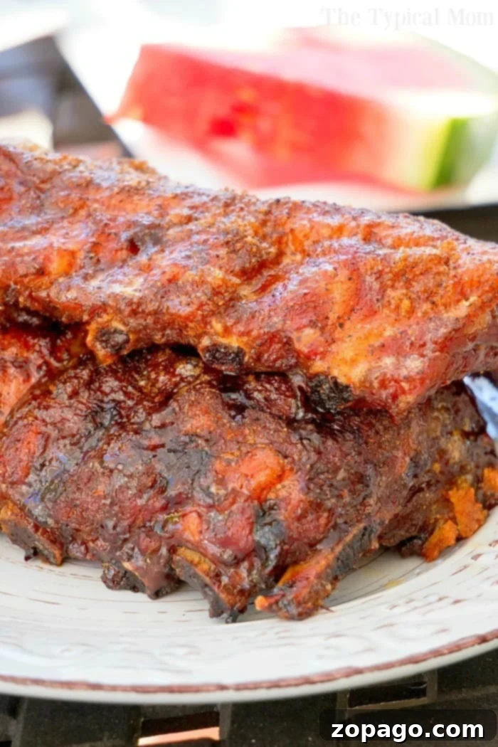 Fall-Off-The-Bone Slow Cooker Ribs 5 Easy Crockpot Ribs served with a vibrant green vegetable side, emphasizing a healthy and delicious meal.