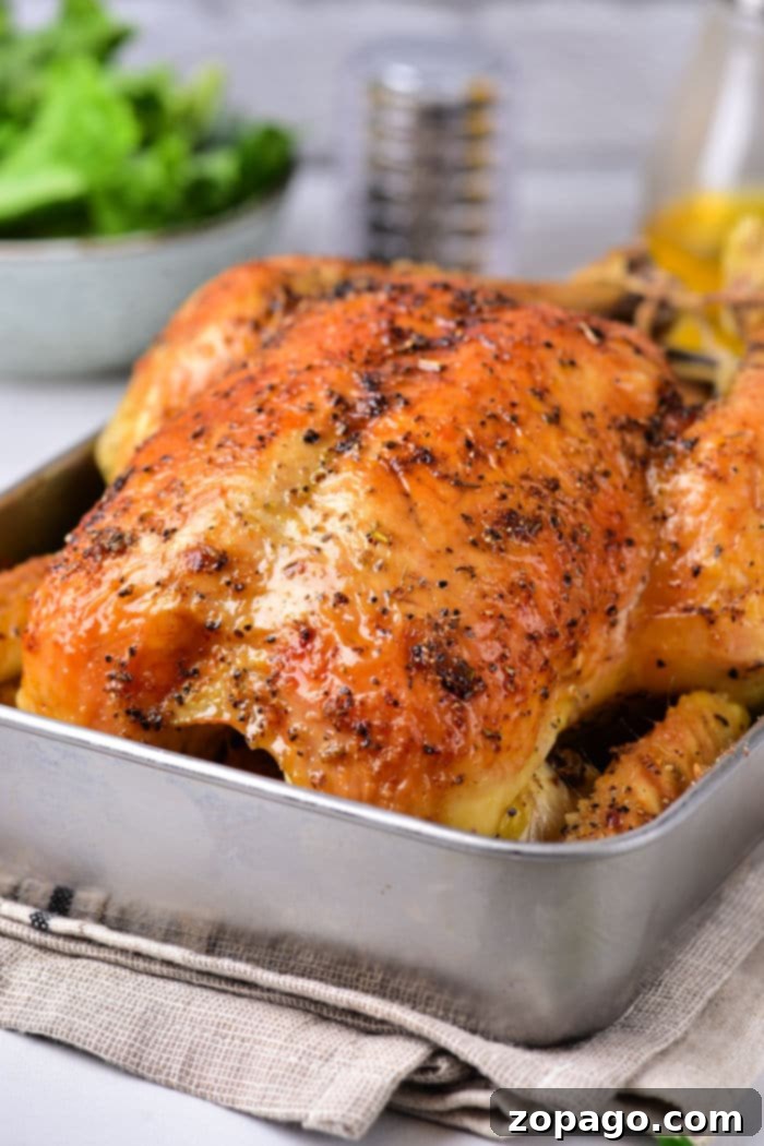 Perfectly Baked Whole Chicken: Your 350F Time Guide 5 A golden brown, whole roasted chicken resting on a cutting board after being removed from the oven. The skin is perfectly crispy and the chicken looks incredibly juicy. This showcases the final, delicious result of baking a whole chicken in the oven.